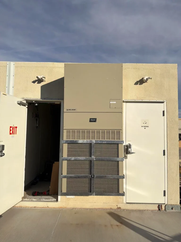 Front view of a Reese Marine flat bar cage protecting an HVAC unit on a commercial building exterior