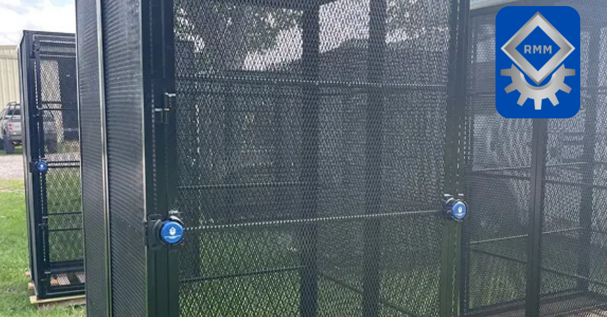 Heavy duty black steel mesh security cages equipped with secure blue puck locks sitting on wood pallets outdoors